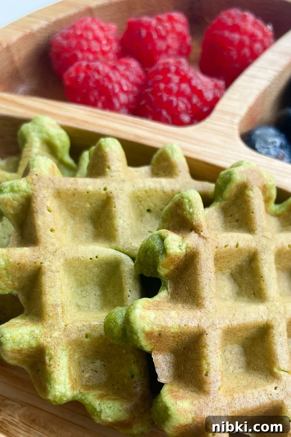 Fluffy Spinach and Banana Waffles Recipe 4 Spinach banana waffles served with raspberries and blueberries