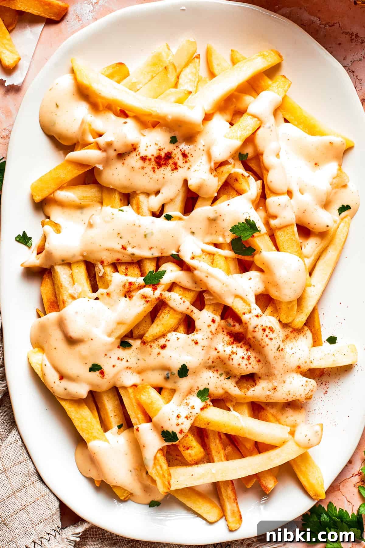 A platter of voodoo fries topped with cheese sauce.