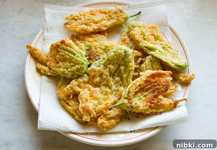 Caprese Zucchini Flowers Filled with Mozzarella and Basil 5 Close up of fried zucchini flower