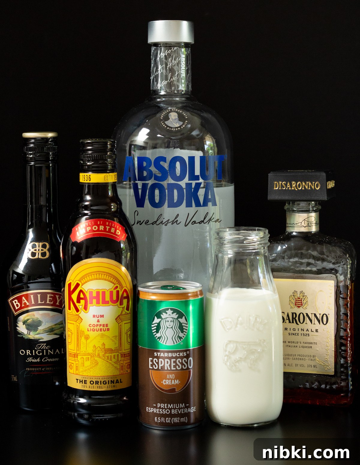 Canned Espresso Martini: Ready-to-Drink Cocktail 2 A bottle of vodka, Bailey's Irish Cream, Kahlua, and Disaronno, as well as a can of Starbucks Espresso and cream and a glass jar of heavy cream.