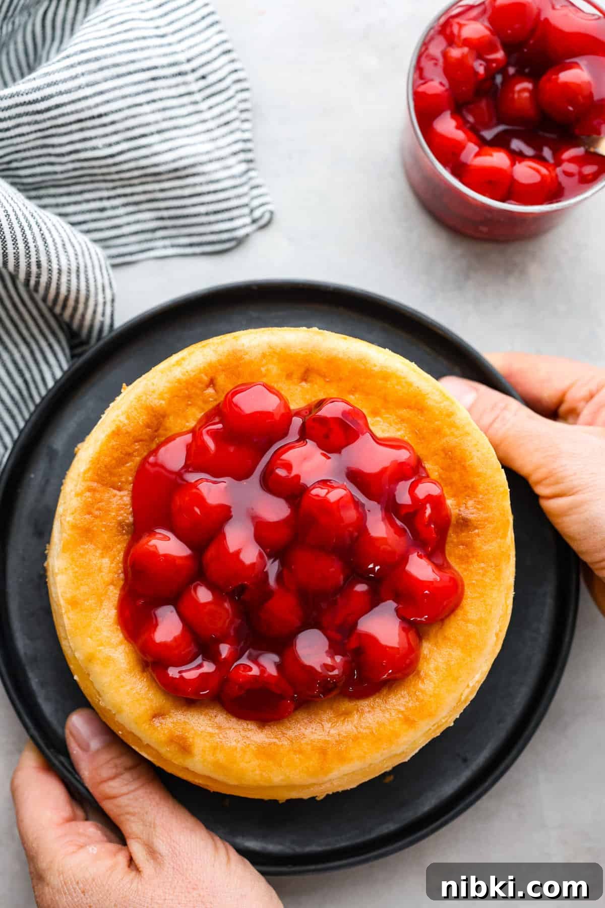 Second photo of a baked cheese cake on a plate.