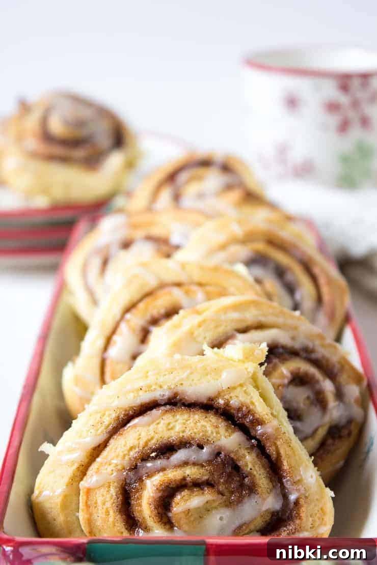Homemade Cinnamon Rolls with Cream Cheese Frosting 4 Breakfast rolls in a rectangular serving dish.