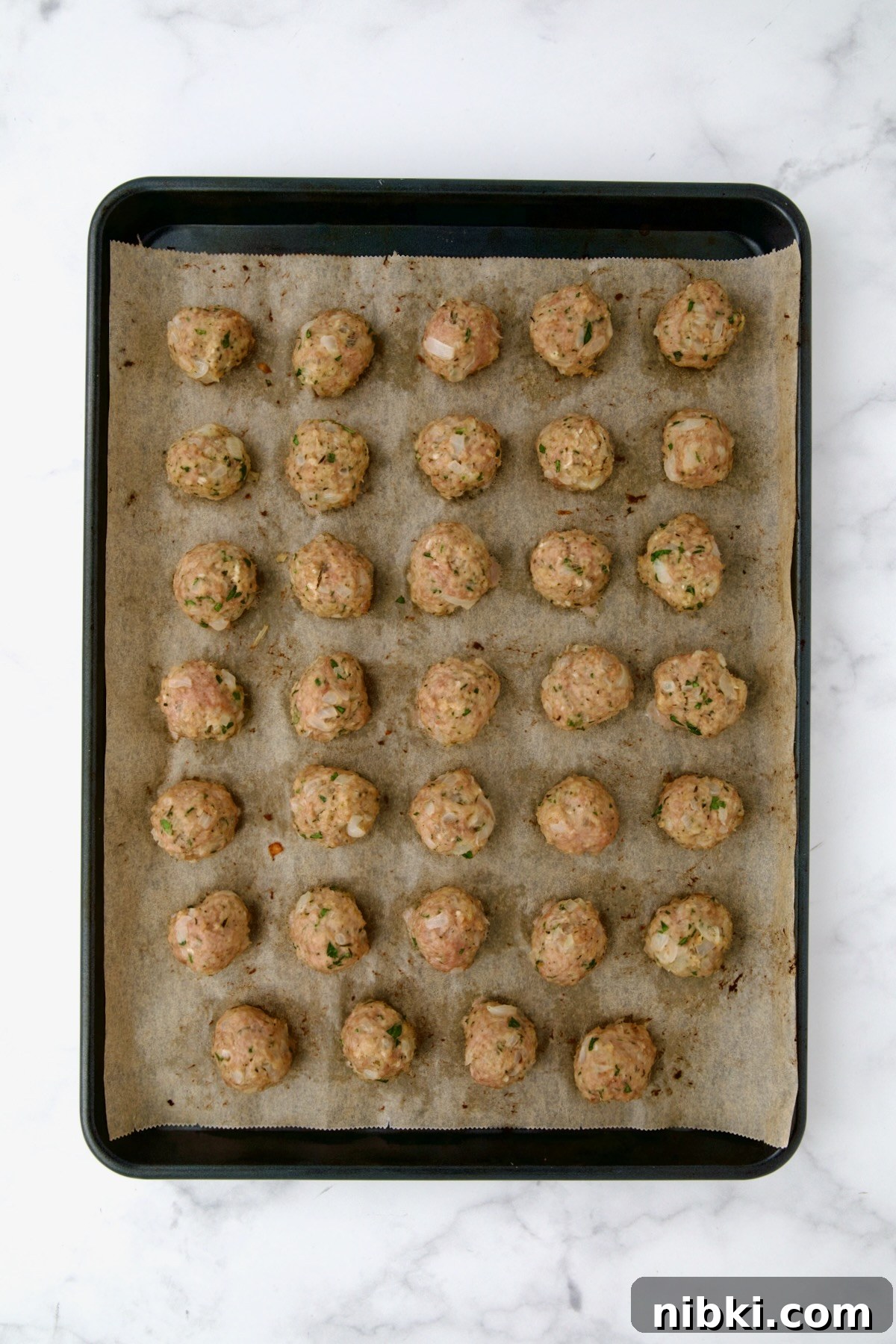 Oven-Baked Turkey Meatballs with Beer Glaze 10 Baked turkey meatballs on sheet pan.