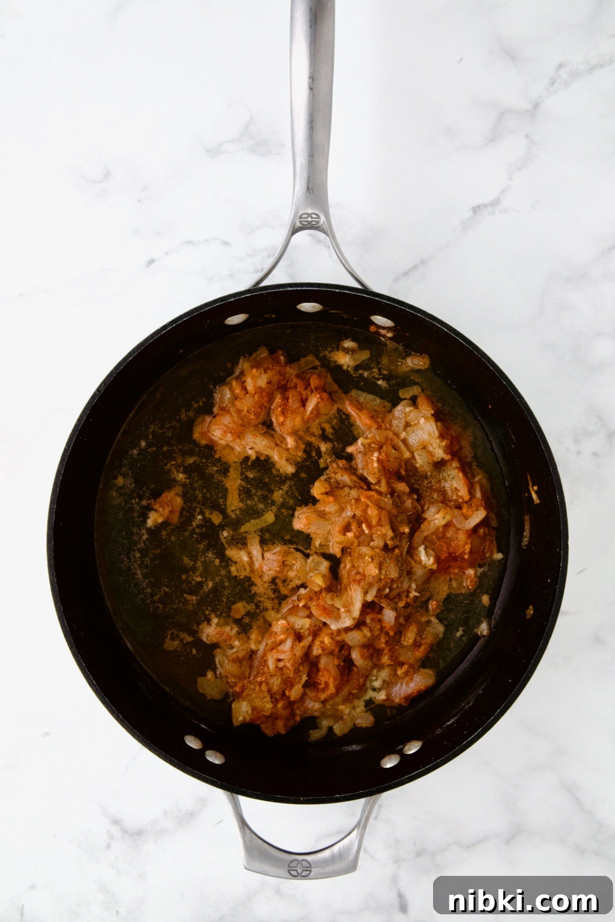 Oven-Baked Turkey Meatballs with Beer Glaze 12 Onions and tomato paste in nonstick skillet.