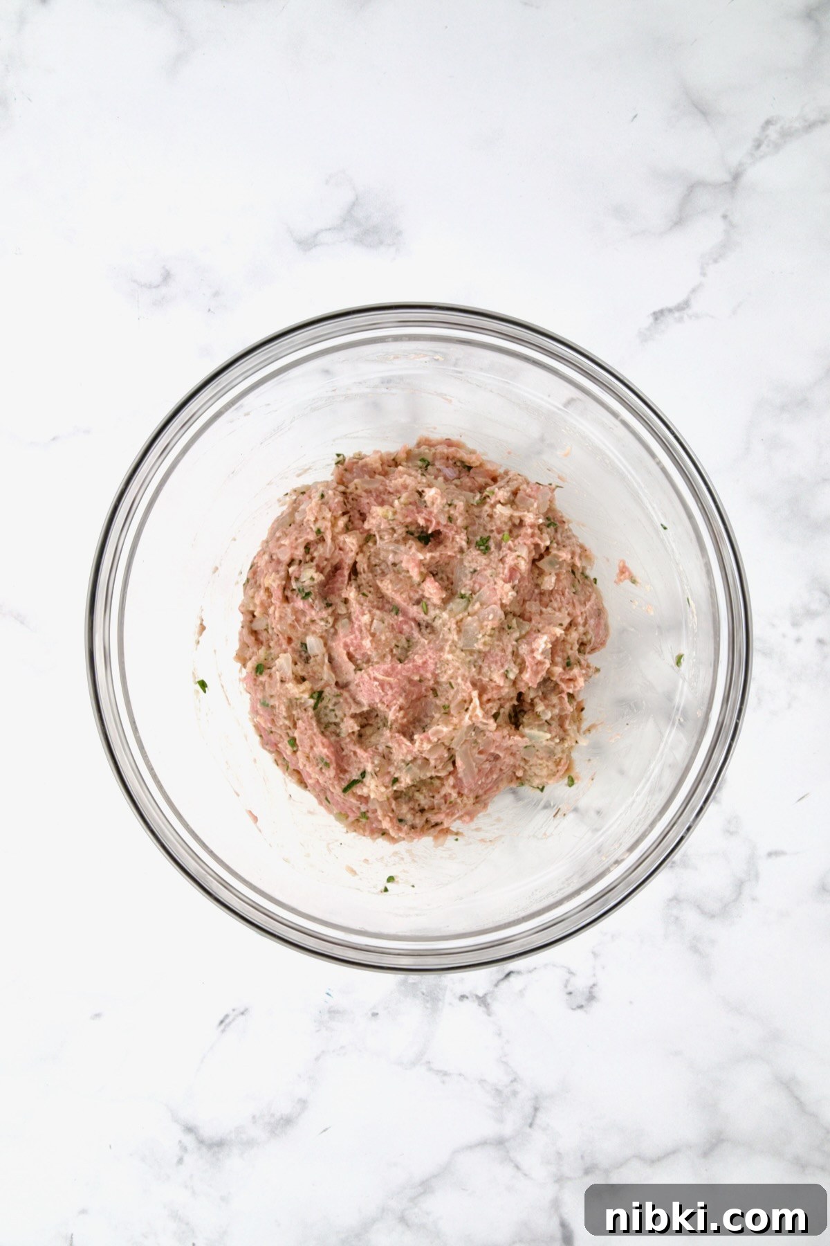 Oven-Baked Turkey Meatballs with Beer Glaze 8 Ingredients for turkey meatballs with ground turkey before being mixed together.