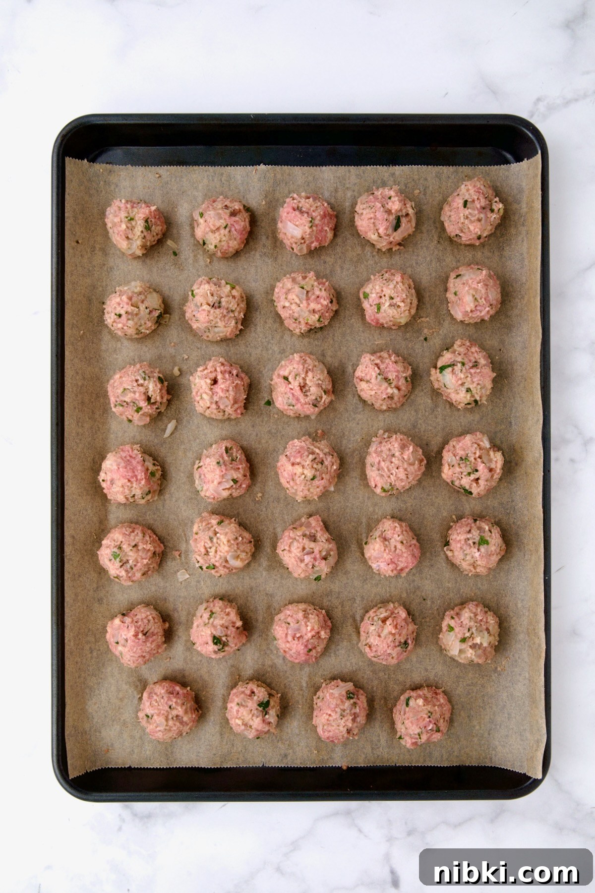 Oven-Baked Turkey Meatballs with Beer Glaze 9 Turkey meatballs on sheet pan before baking.