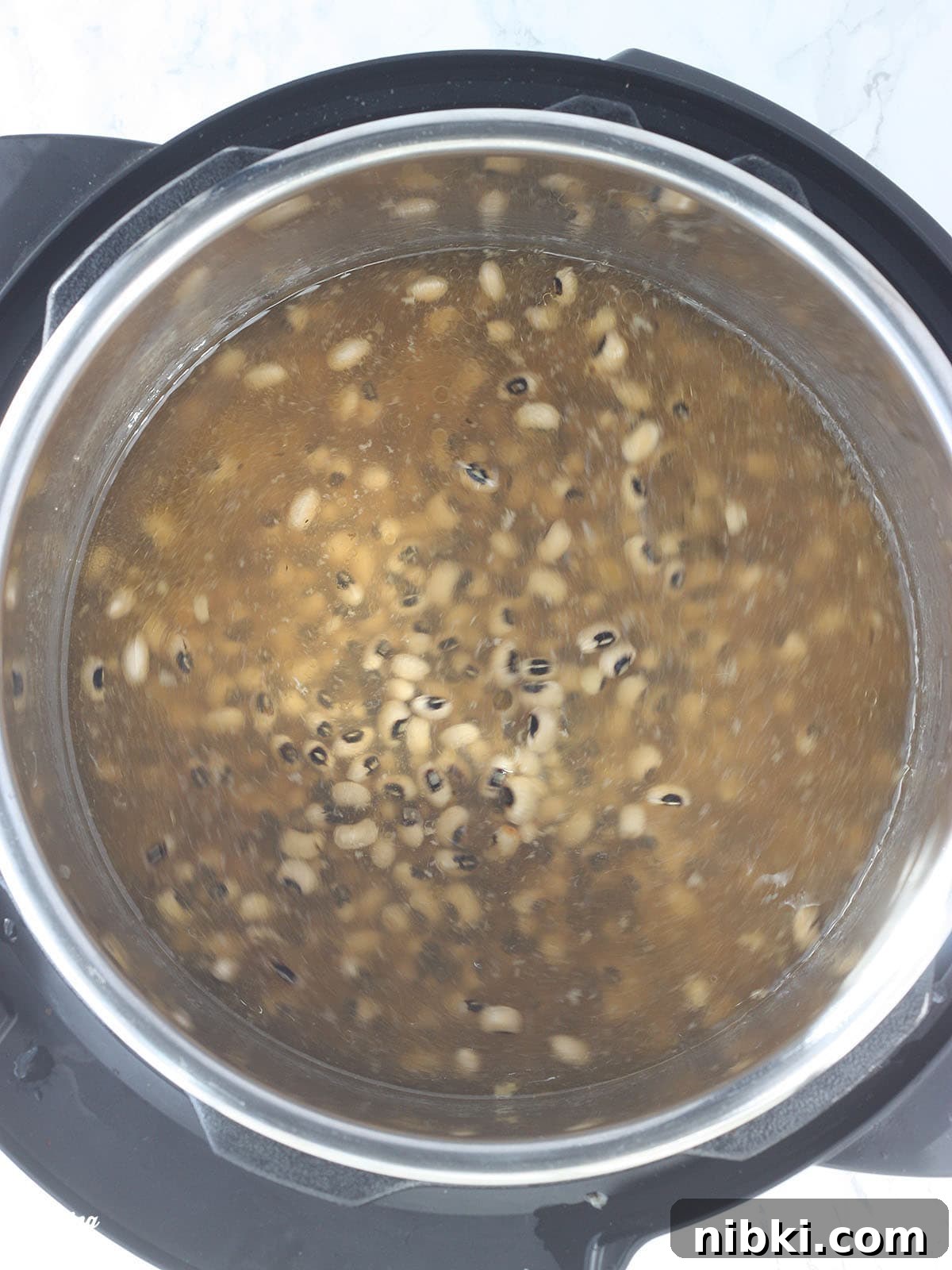 Instant Pot Hoppin' John: Southern Black-Eyed Peas and Rice 5 Black-eyed peas and broth after presoaking in an Instant Pot