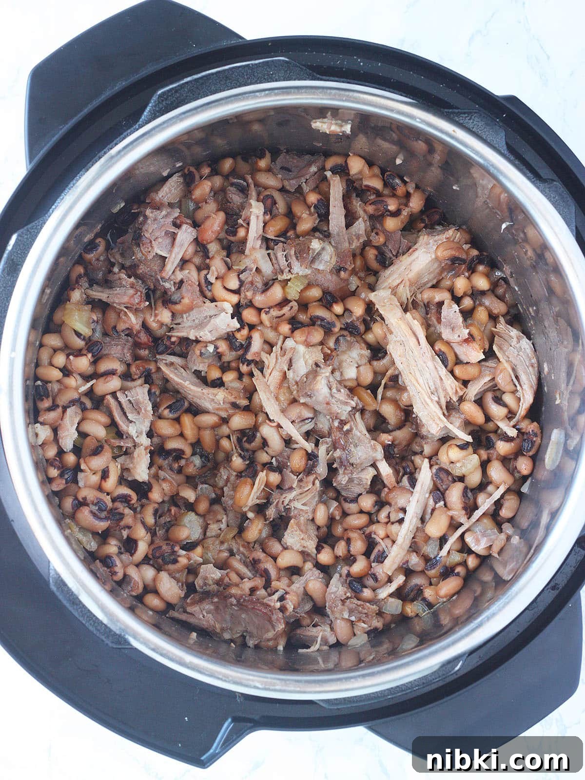 Instant Pot Hoppin' John: Southern Black-Eyed Peas and Rice 8 Overhead shot of cooked black-eyed peas with shredded pork in an Instant Pot