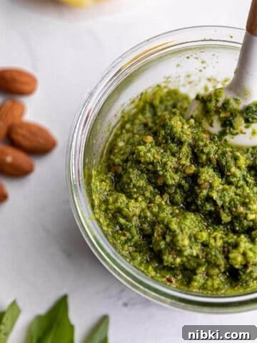 Homemade Lemon Garlic Aioli Recipe 6 A jar with a fresh pesto and white spatula.