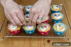 Place the sweets on top of the fairy cakes