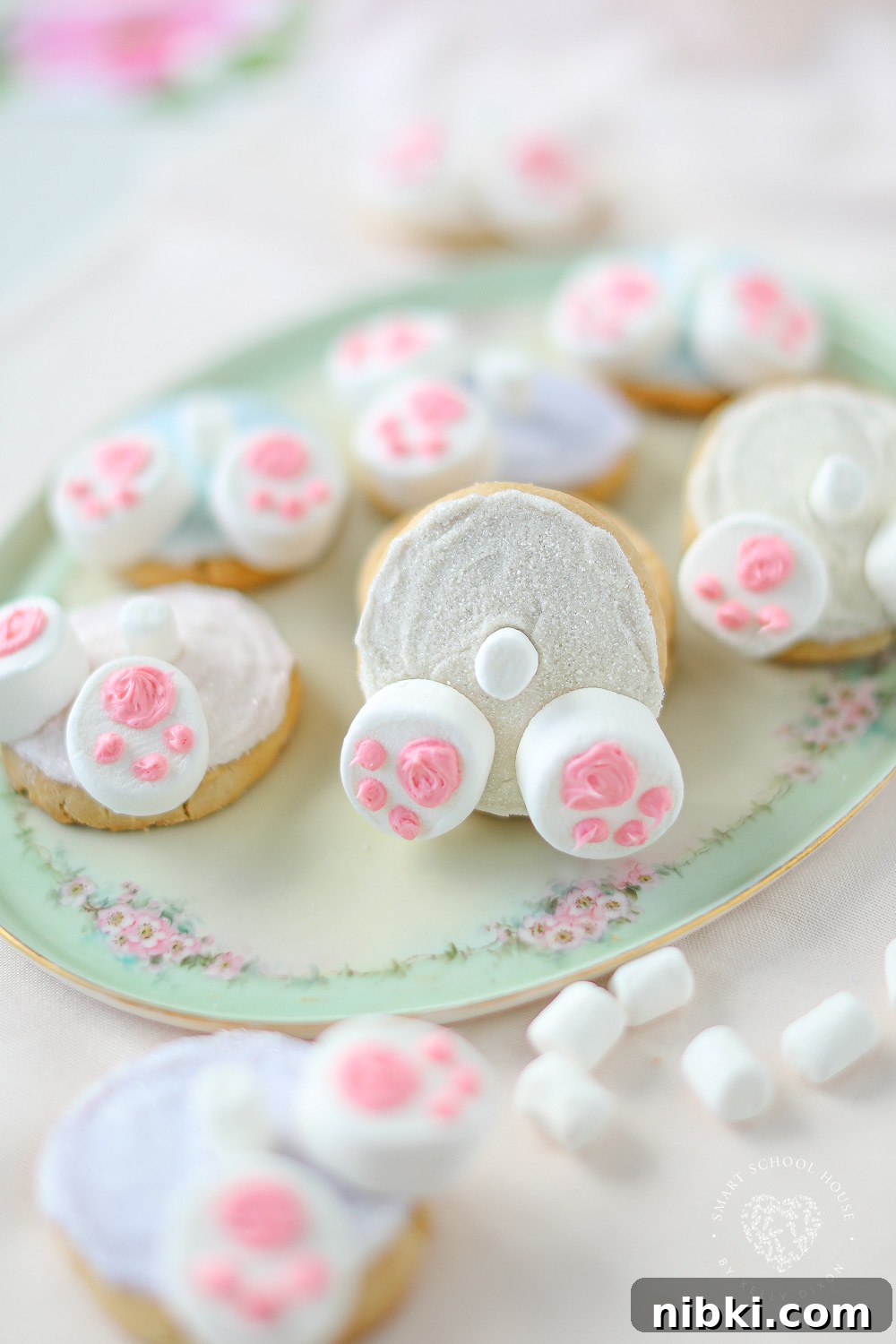 Bunny Butt Cookies are frosted Easter cookies that feature little bunny paws made with marshmallows and a little white marshmallow tail.