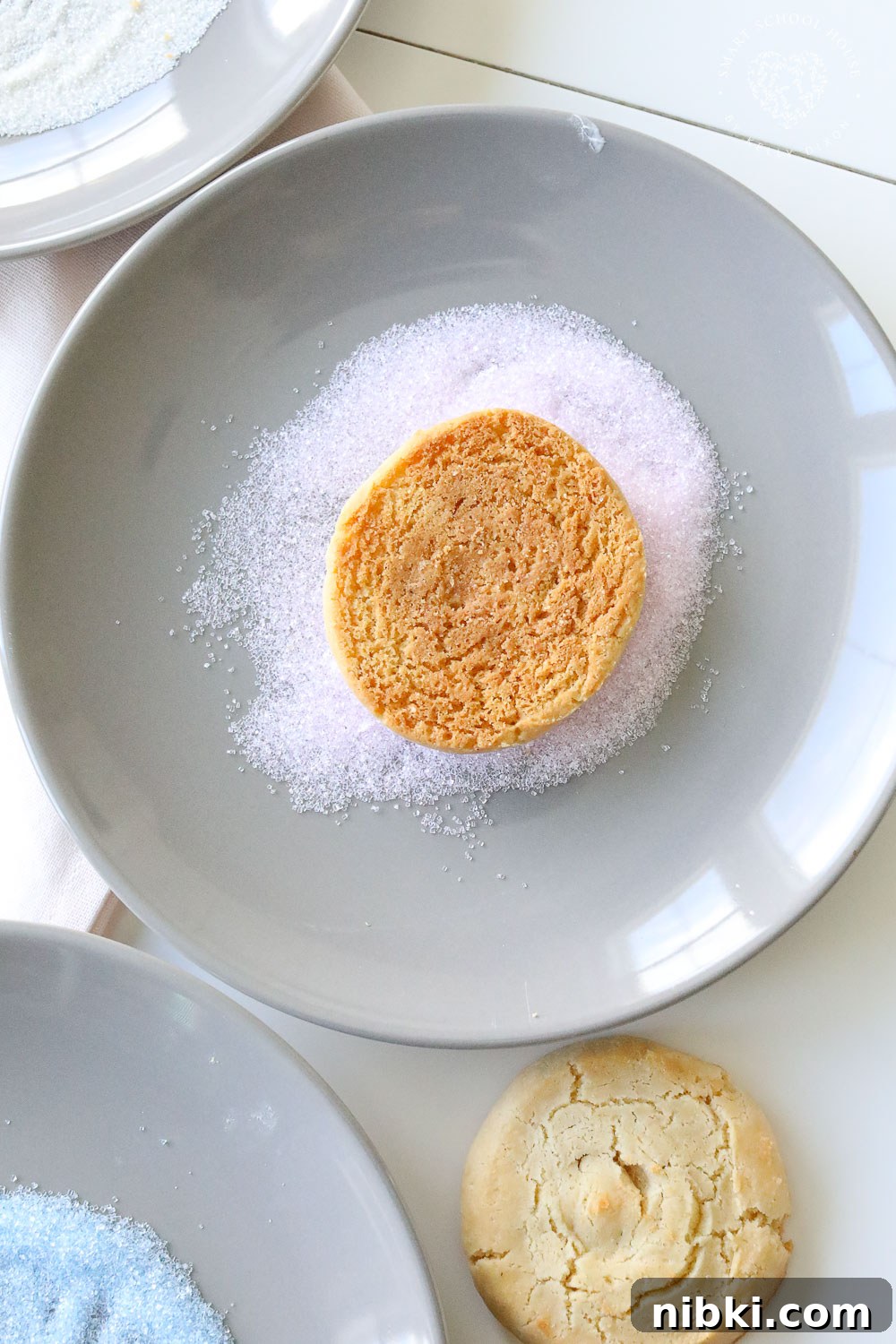 Pressing cookies into sprinkles