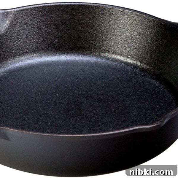 A black cast iron skillet with a handle.
