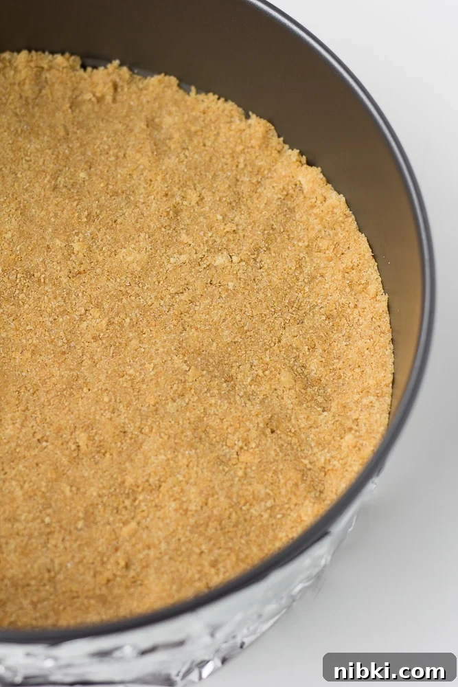 How to Make a Creamy Vegan Cheesecake 5 graham cracker crust in a springform pan not yet cooked