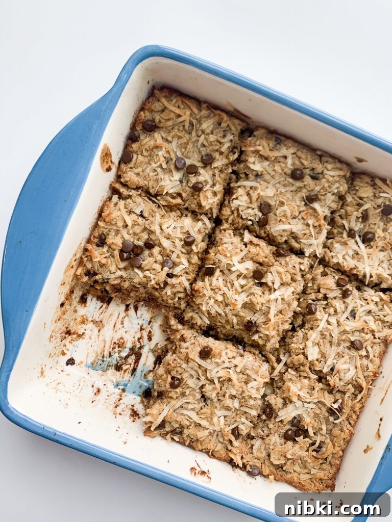 Almond Joy Inspired Chocolate Coconut Baked Oatmeal 7 baked oatmeal in a blue baking dish with one square taken out
