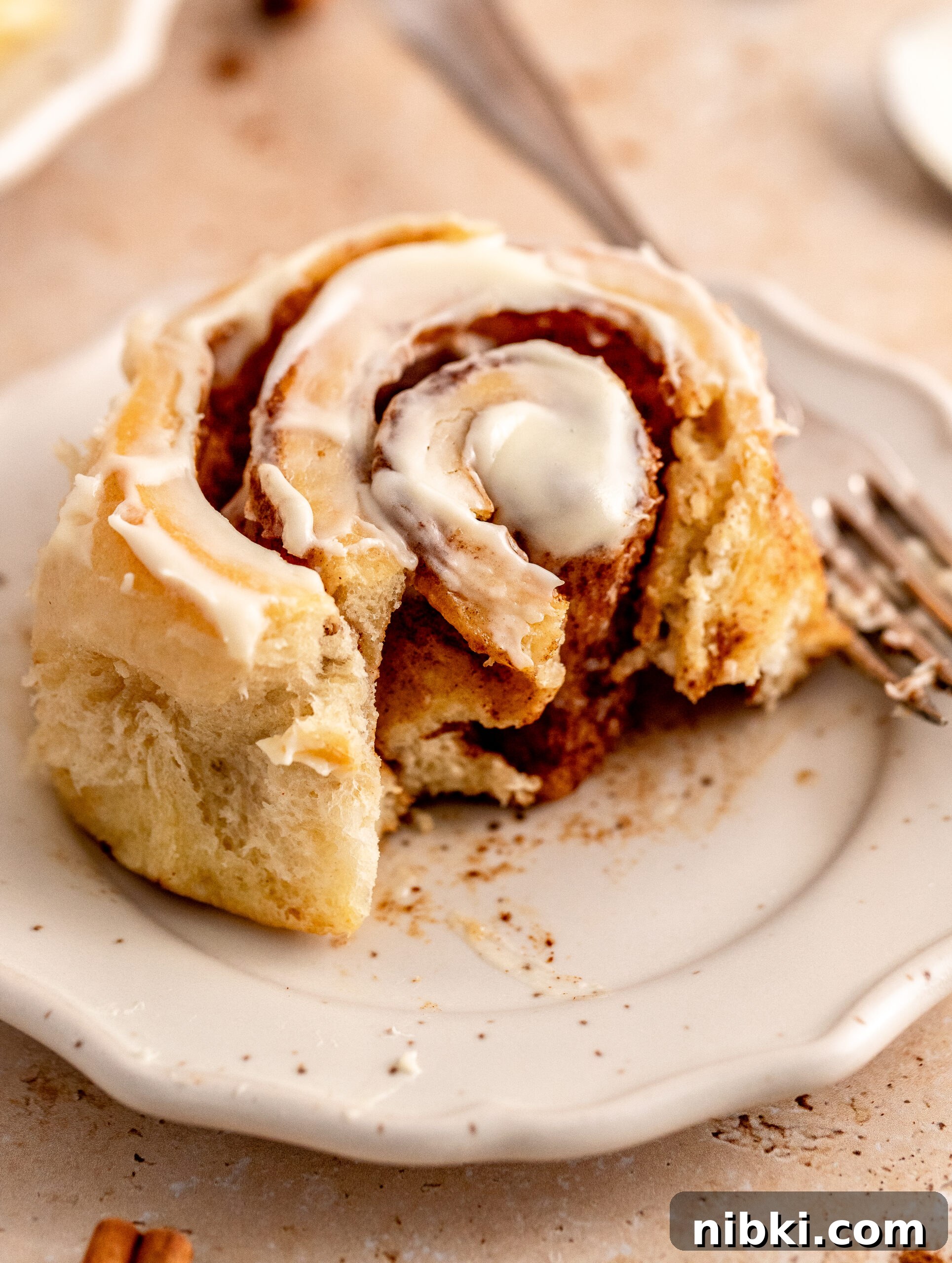 Brioche Cinnamon Rolls Recipe with Vanilla Glaze 10 Brioche cinnamon rolls on a plate.