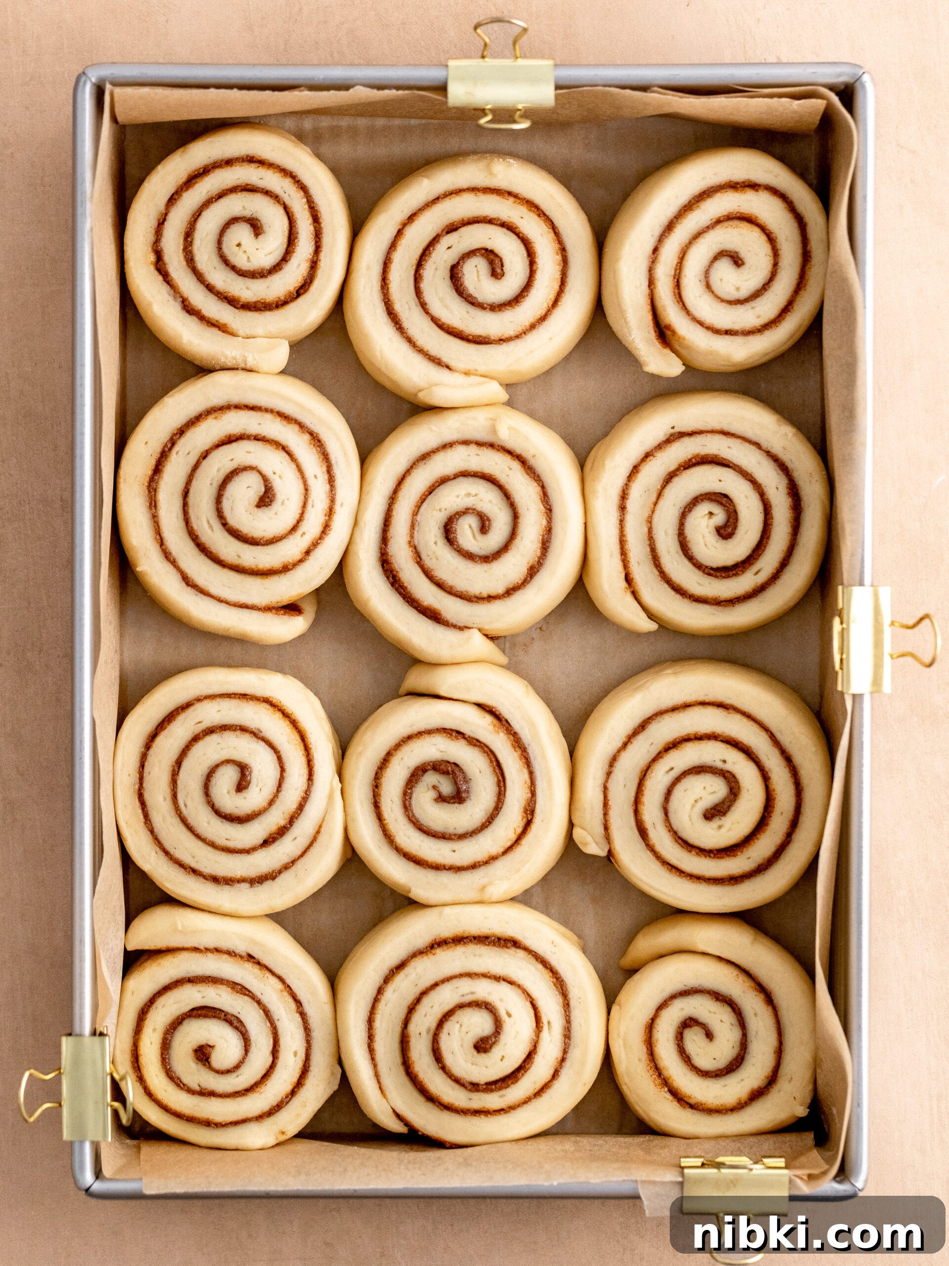 Brioche Cinnamon Rolls Recipe with Vanilla Glaze 6 Cinnamon rolls in the baking tray, after the 2nd rise, ready to go into the oven.