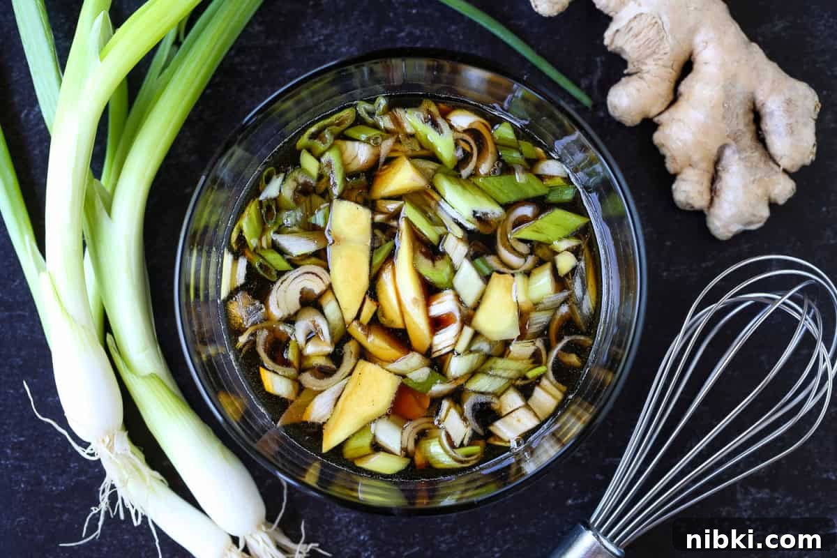 teriyaki steak marinade in bowl with scallions and ginger