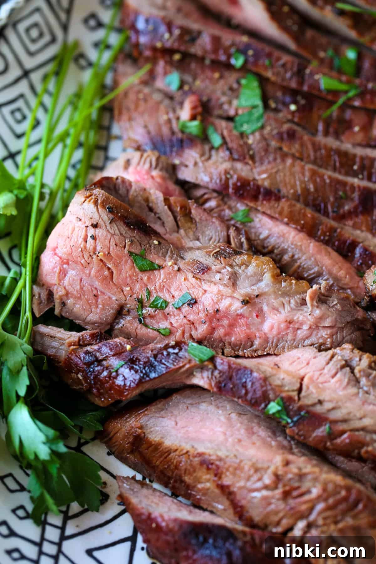 sliced flank steak with chopped parsley