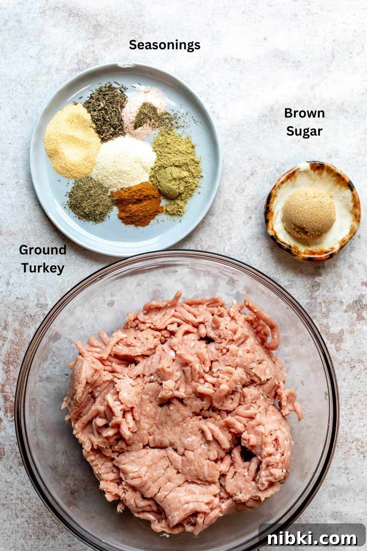 Homemade Turkey Sausage with Garlic and Fresh Herbs 3 An image of ground turkey in a bowl and seasonings on a plate.