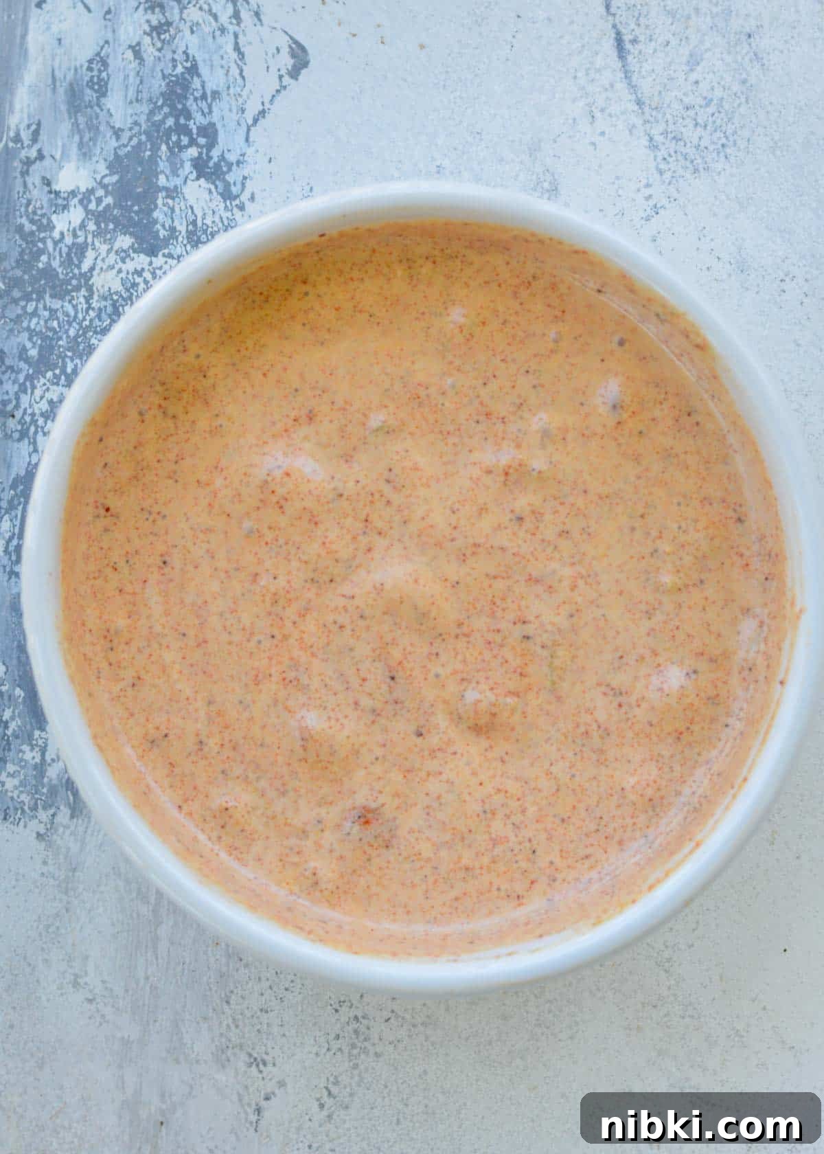 Copycat Taco Bell Creamy Jalapeno Sauce Recipe 2 A white ramekin with a creamy jalapeno sauce copycat