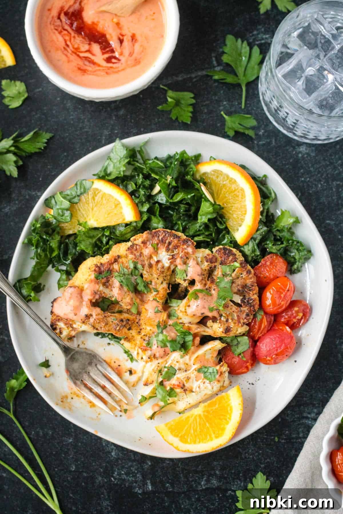How to Make Crispy Vegan Roasted Cauliflower Steaks 8 Slice of roasted cauliflower with a bite missing.