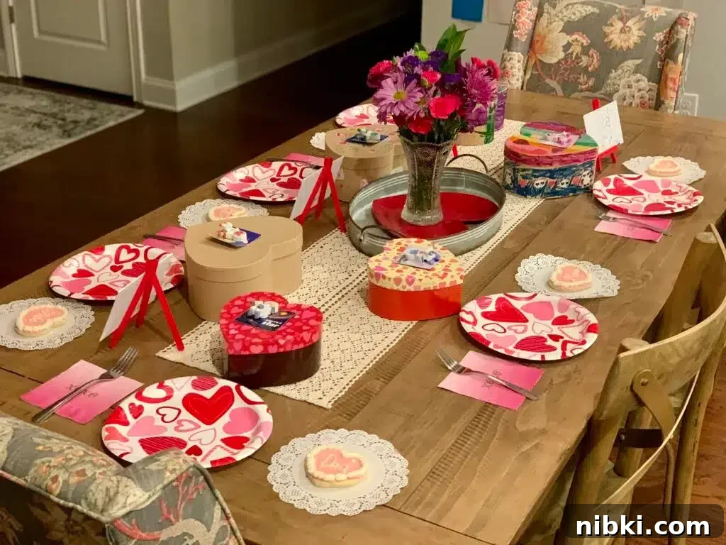 No-Chill Soft Sugar Cookies That Stay Tender and Chewy 3 A table is set for Valentine's Day with red and pink heart plates and cookies set at each place setting.