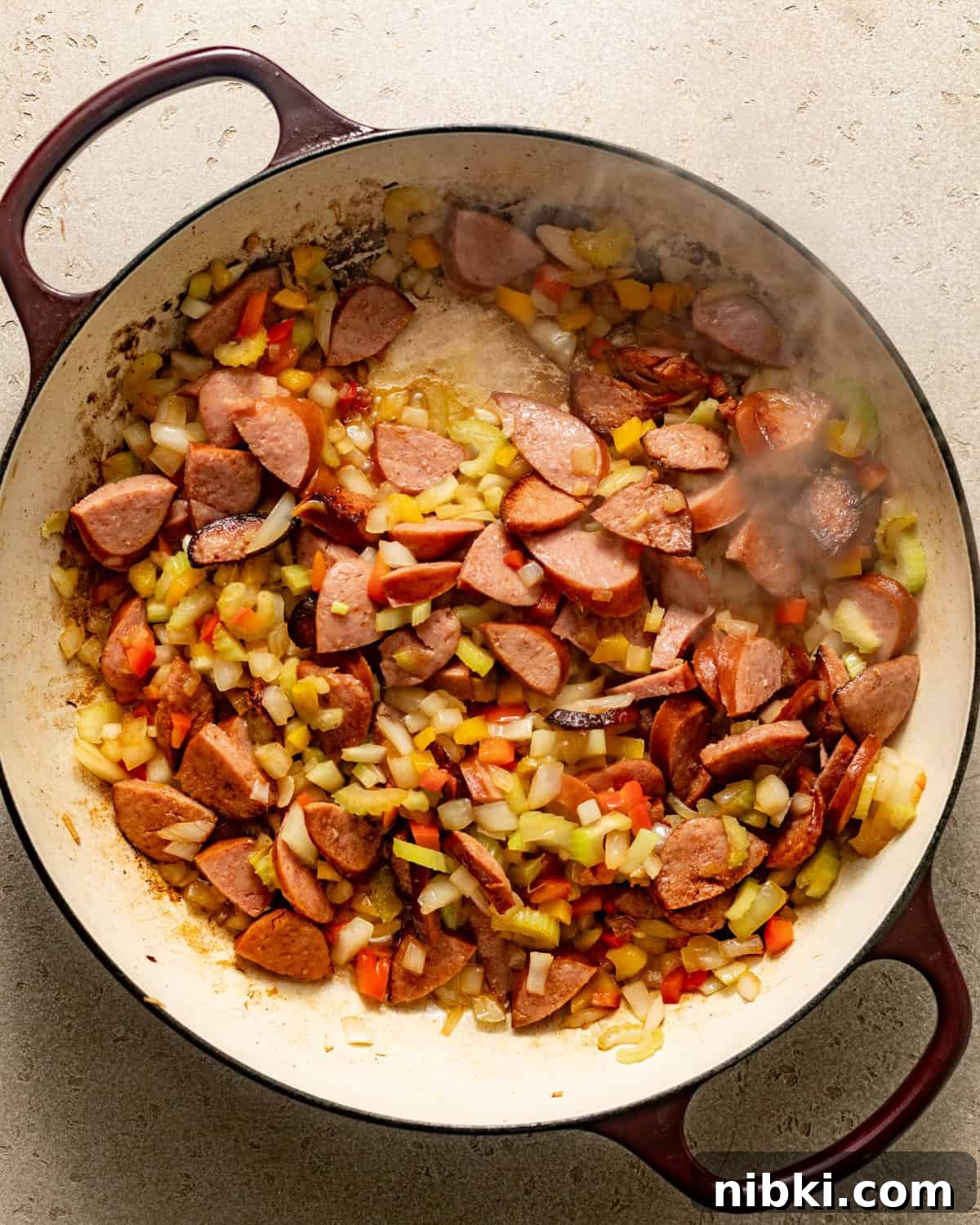 Authentic Louisiana Dirty Rice Recipe 3 sausage and vegetables cooked in a pot.