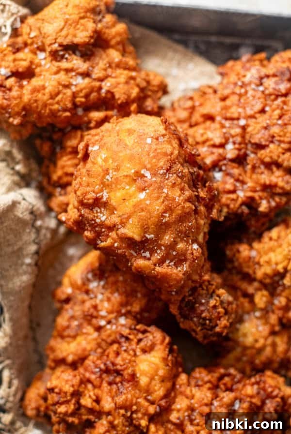 Authentic Louisiana Dirty Rice Recipe 9 piece of fried chicken in a serving basket with a sprinkle of flaky sea salt on top.