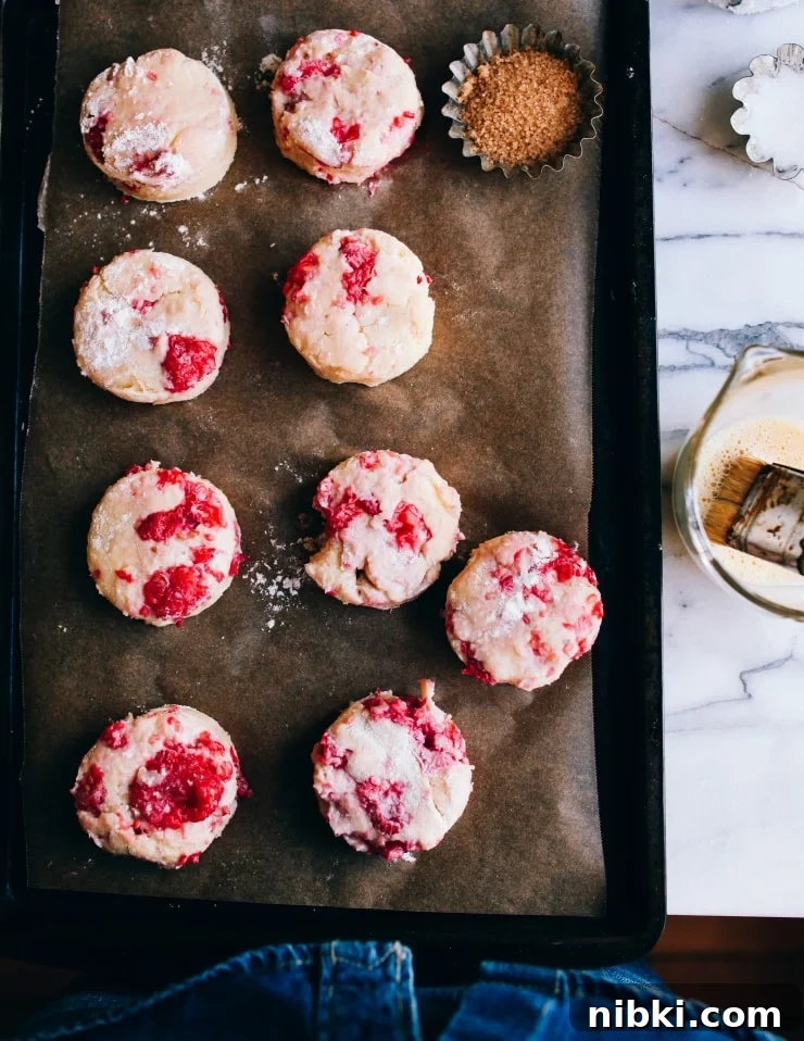 Flaky Homemade Raspberry Scones with Lemon Glaze 10 Round unbaked raspberry fruit scones | sophisticatedgourmet.com
