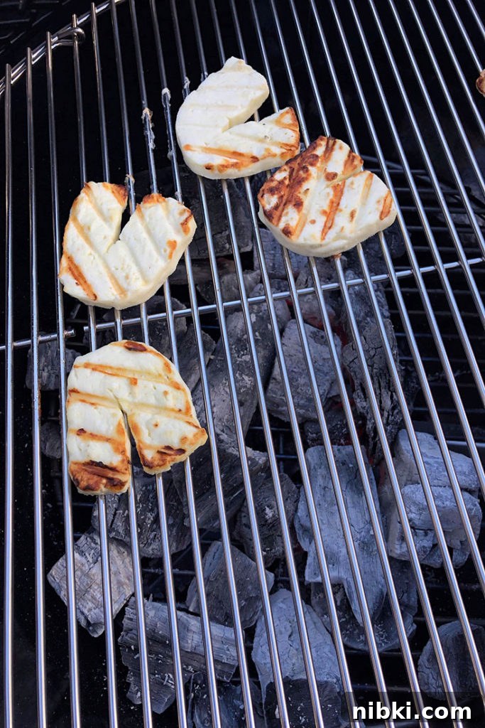 Crispy Grilled or Pan-Fried Halloumi Recipe 4 Grilled halloumi cheese slices cooking on a grill.