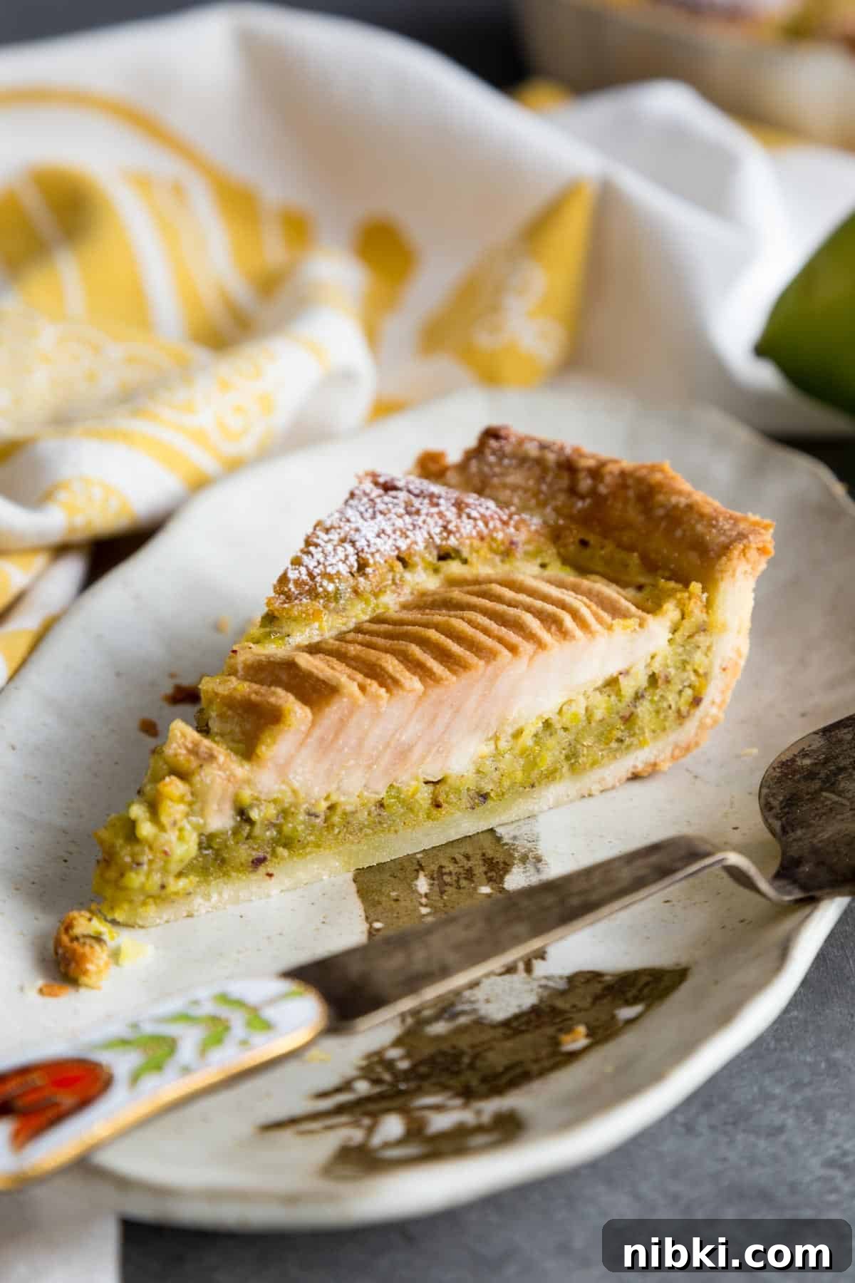 Pear Pistachio Frangipane Tart slice on a plate.