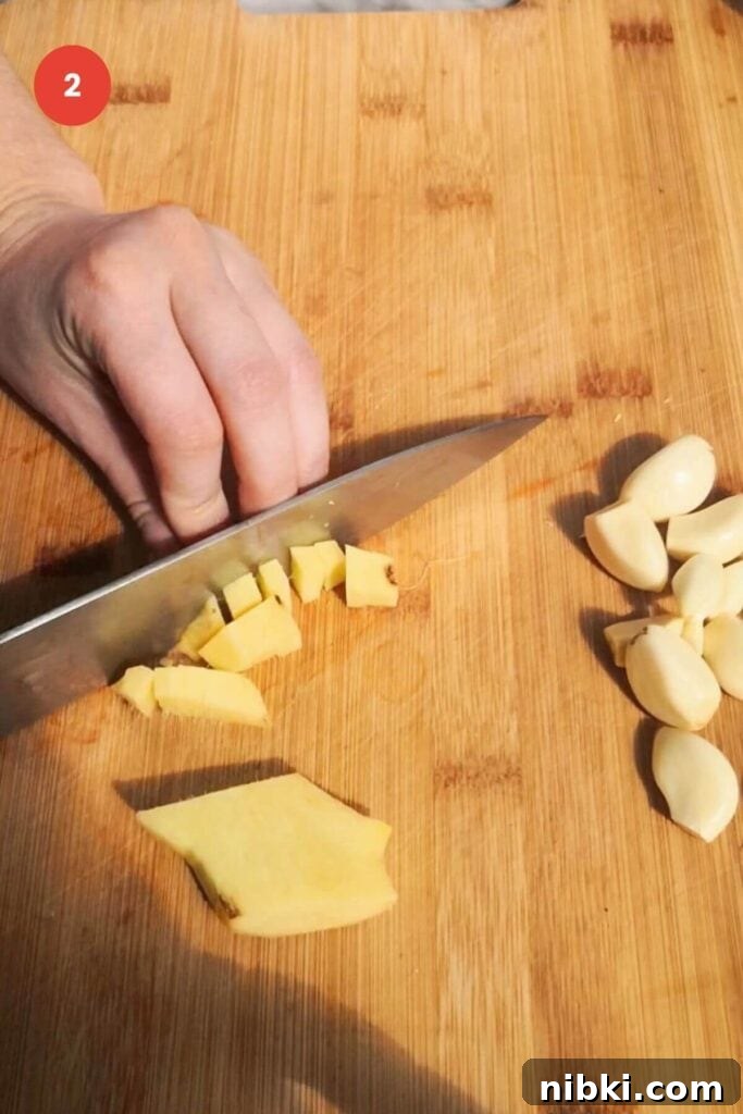 30-Minute Sweet Chili Jam Recipe 4 Slicing ginger on a chopping board.