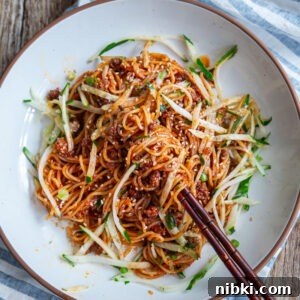 Gochujang noodles made with ground beef served in a bowl.