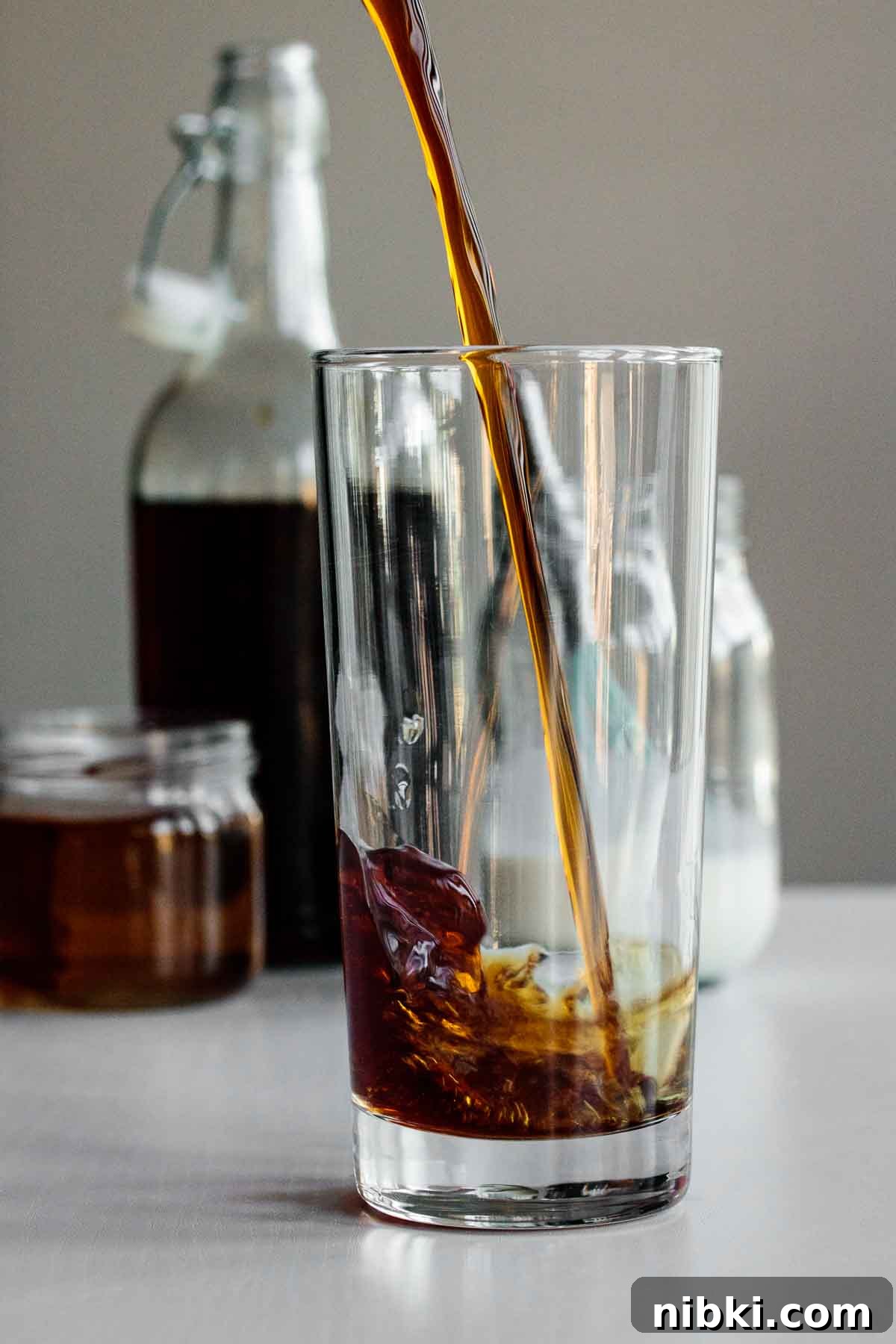 How to Make Starbucks Vanilla Sweet Cream Cold Brew at Home 3 cold brew being poured into tall glass