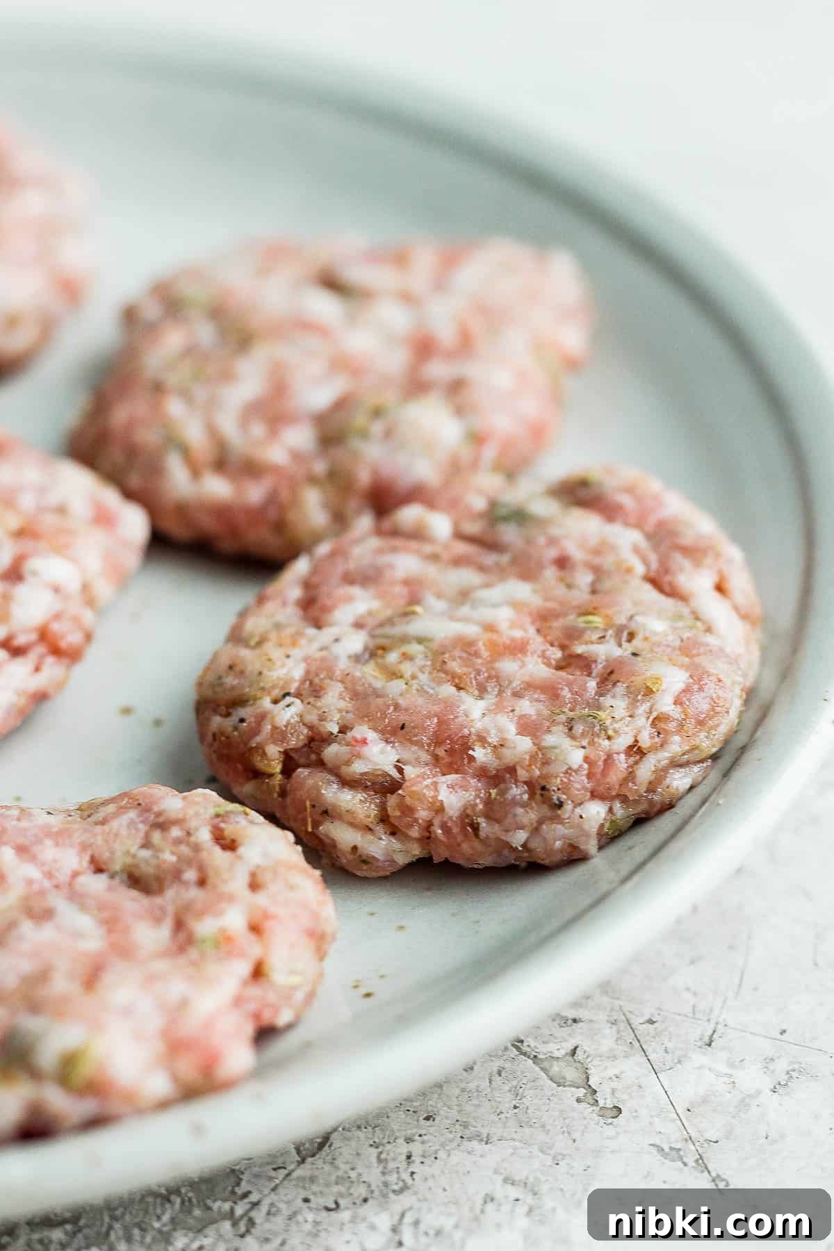 Sausage patties on a white plate.