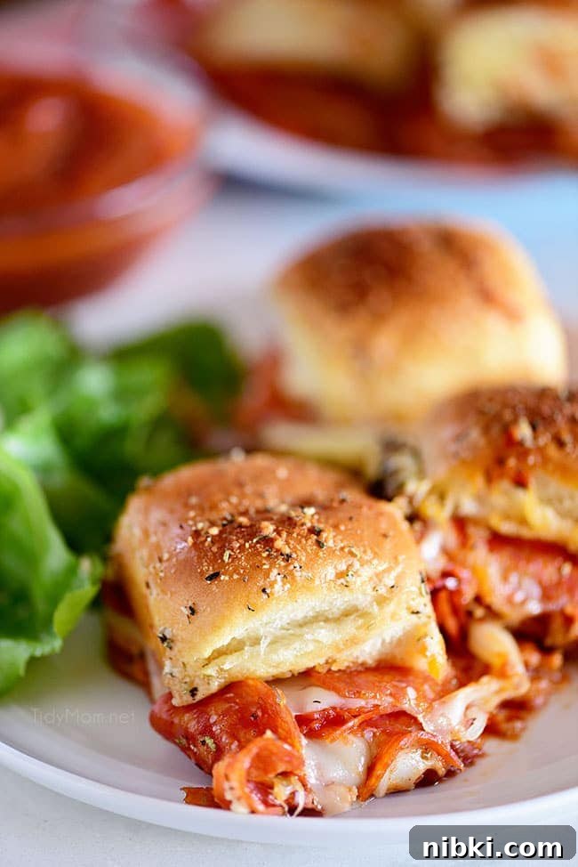 How to Make Pepperoni Pizza Sliders (Video) 2 three pepperoni Pizza Sliders on a plate