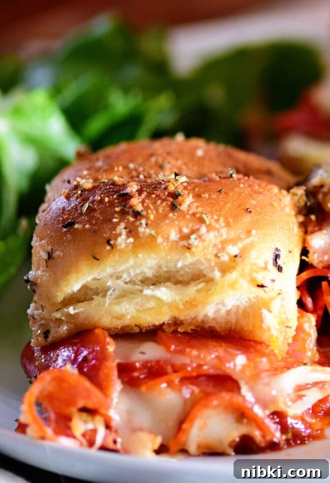 How to Make Pepperoni Pizza Sliders (Video) 3 close up of a pepperoni pizza slider on a plate