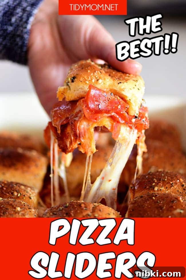 How to Make Pepperoni Pizza Sliders (Video) 4 pizza slider with cheese pulling as it comes out of the dish