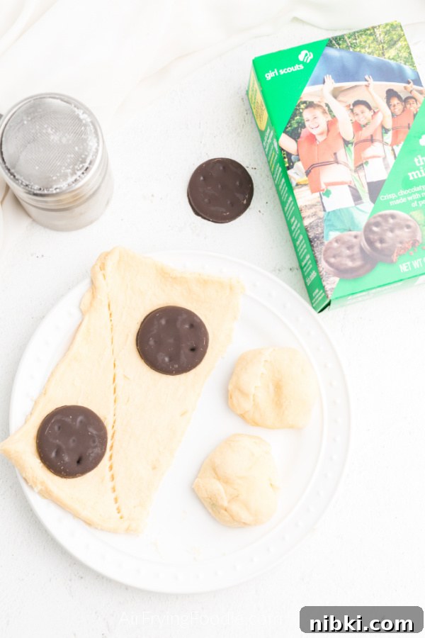 Ingredients needed for air fryer thin mints: think mints on crescent dough sheets, getting ready to be rolled and fried. 