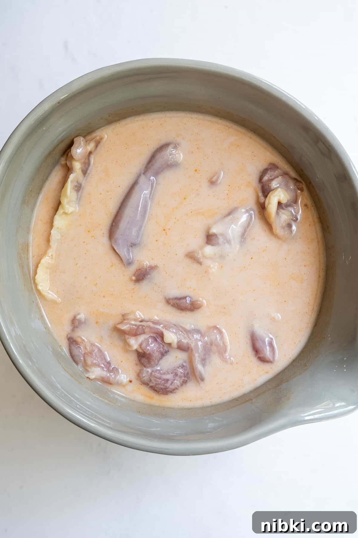 fried chicken marinating in buttermilk