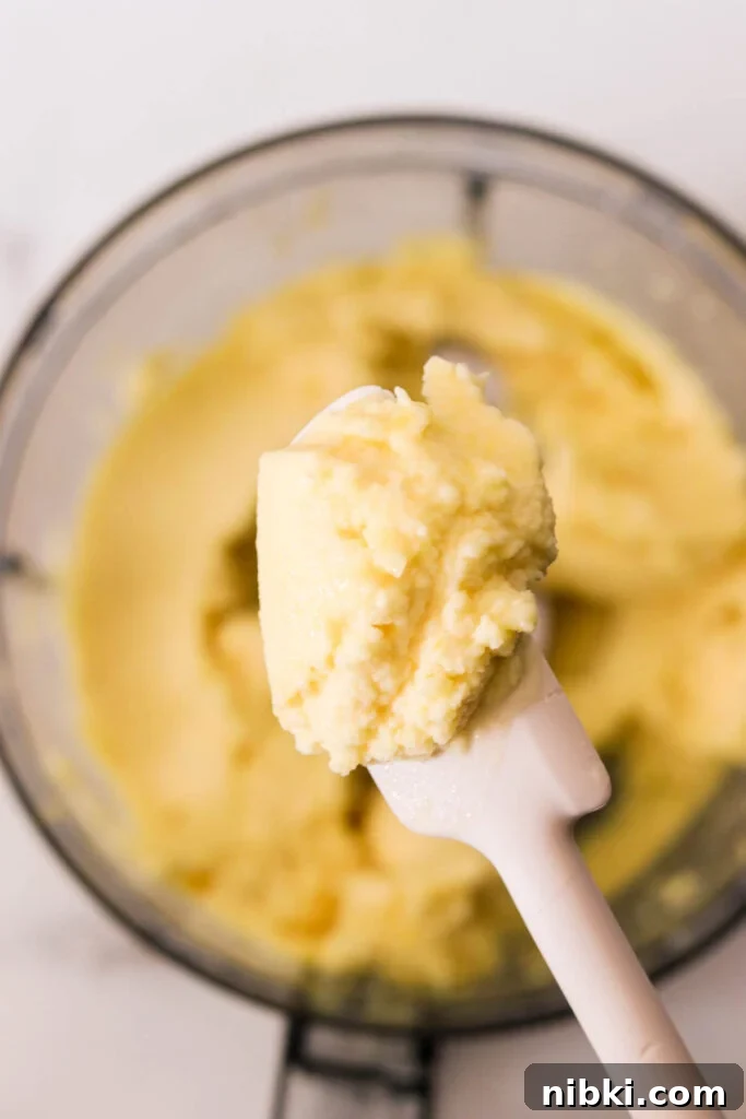 Copycat Disney Pineapple Dole Whip Recipe 4 Blended pineapple Dole Whip mixture in a food processor, creamy soft-serve texture