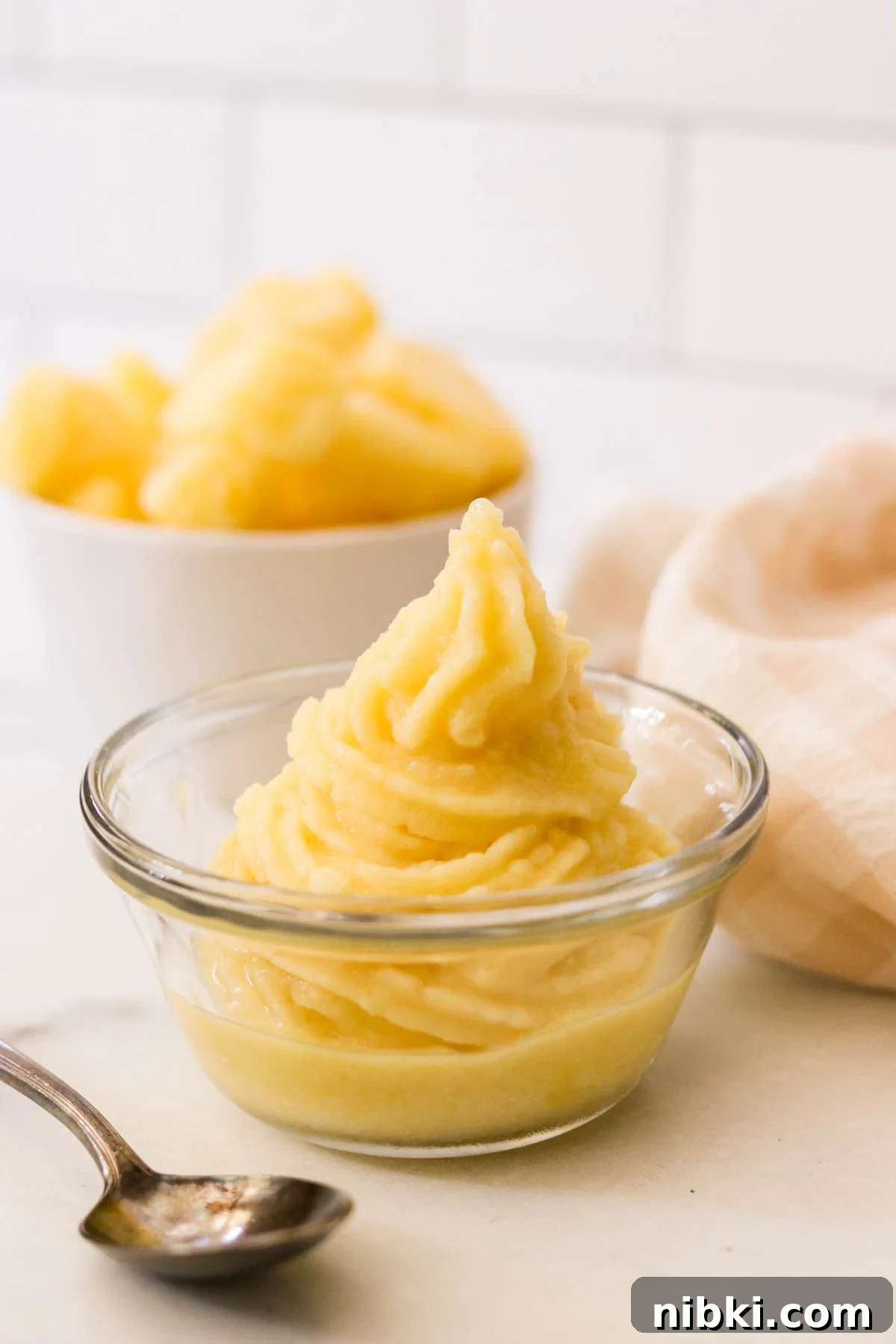 Copycat Disney Pineapple Dole Whip Recipe 6 Close-up of pineapple soft serve in a swirl, served as a Disney-inspired frozen treat