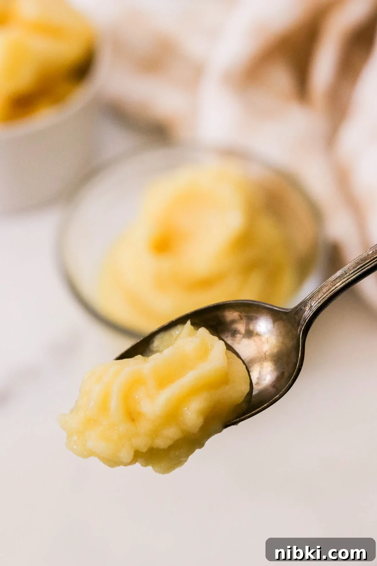 Copycat Disney Pineapple Dole Whip Recipe 7 Frozen pineapple dessert scooped onto a spoon