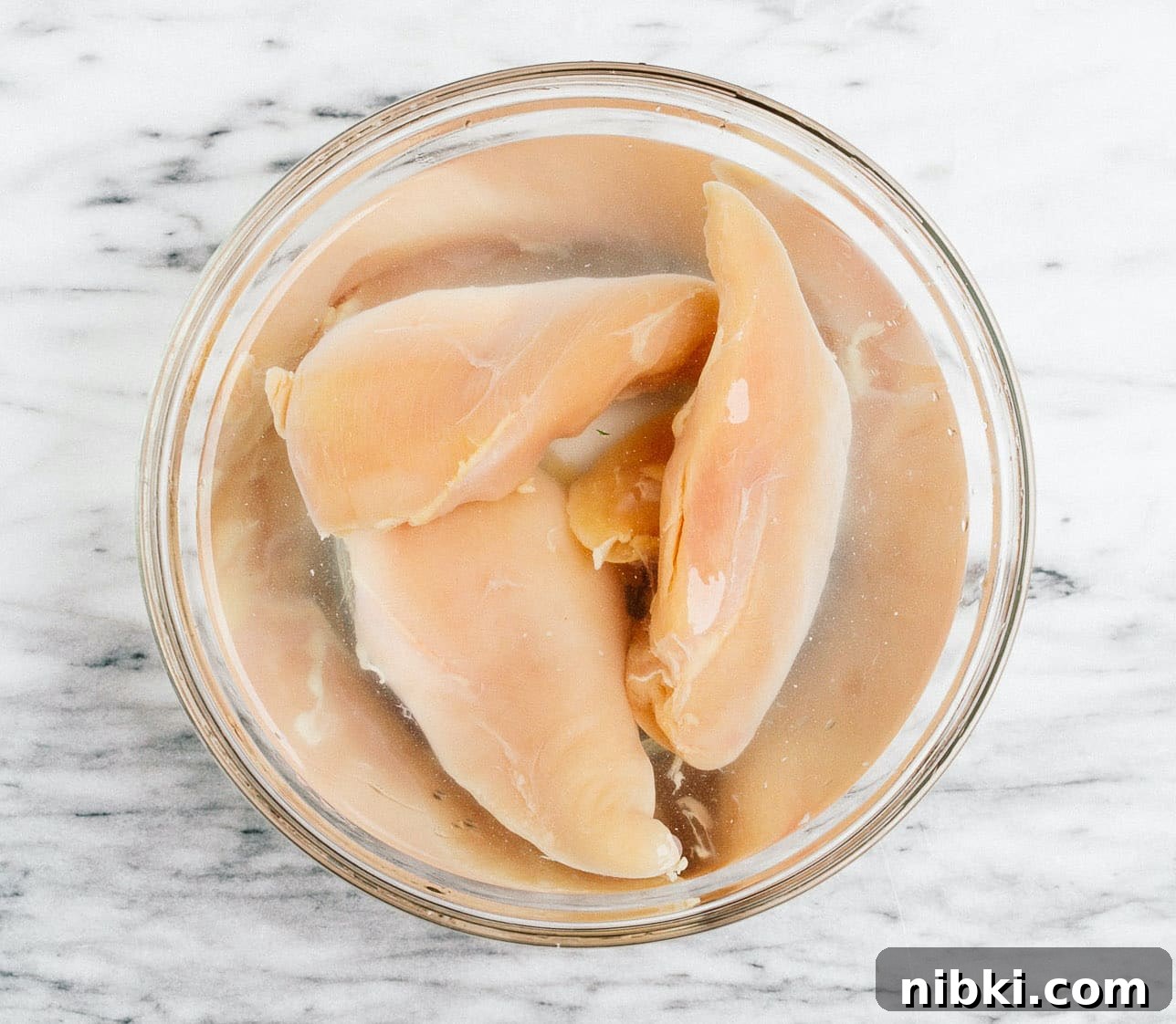 Juicy Grilled Chicken with Chimichurri Recipe 3 raw chicken in a bowl with water