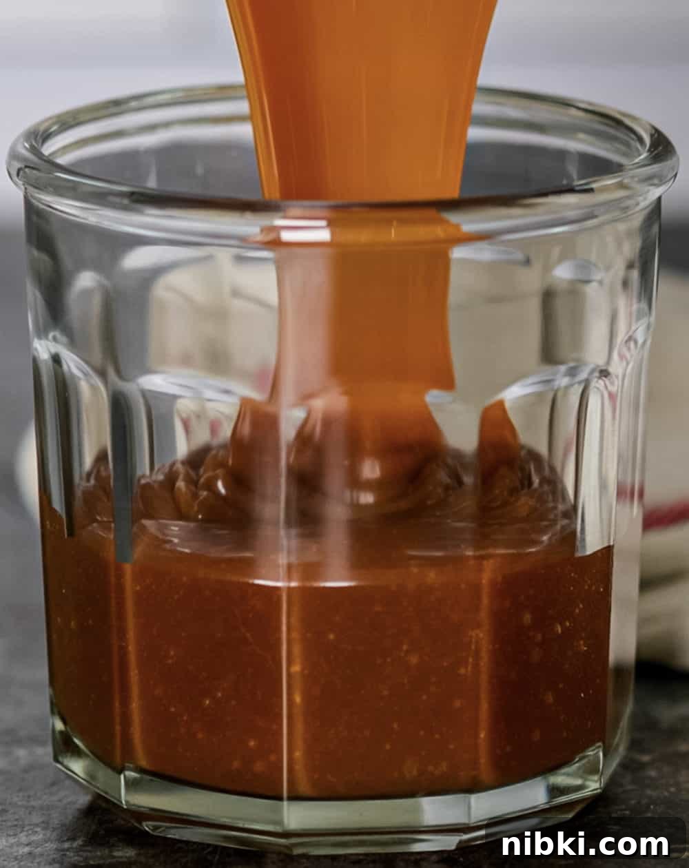 caramel being poured into a glass container