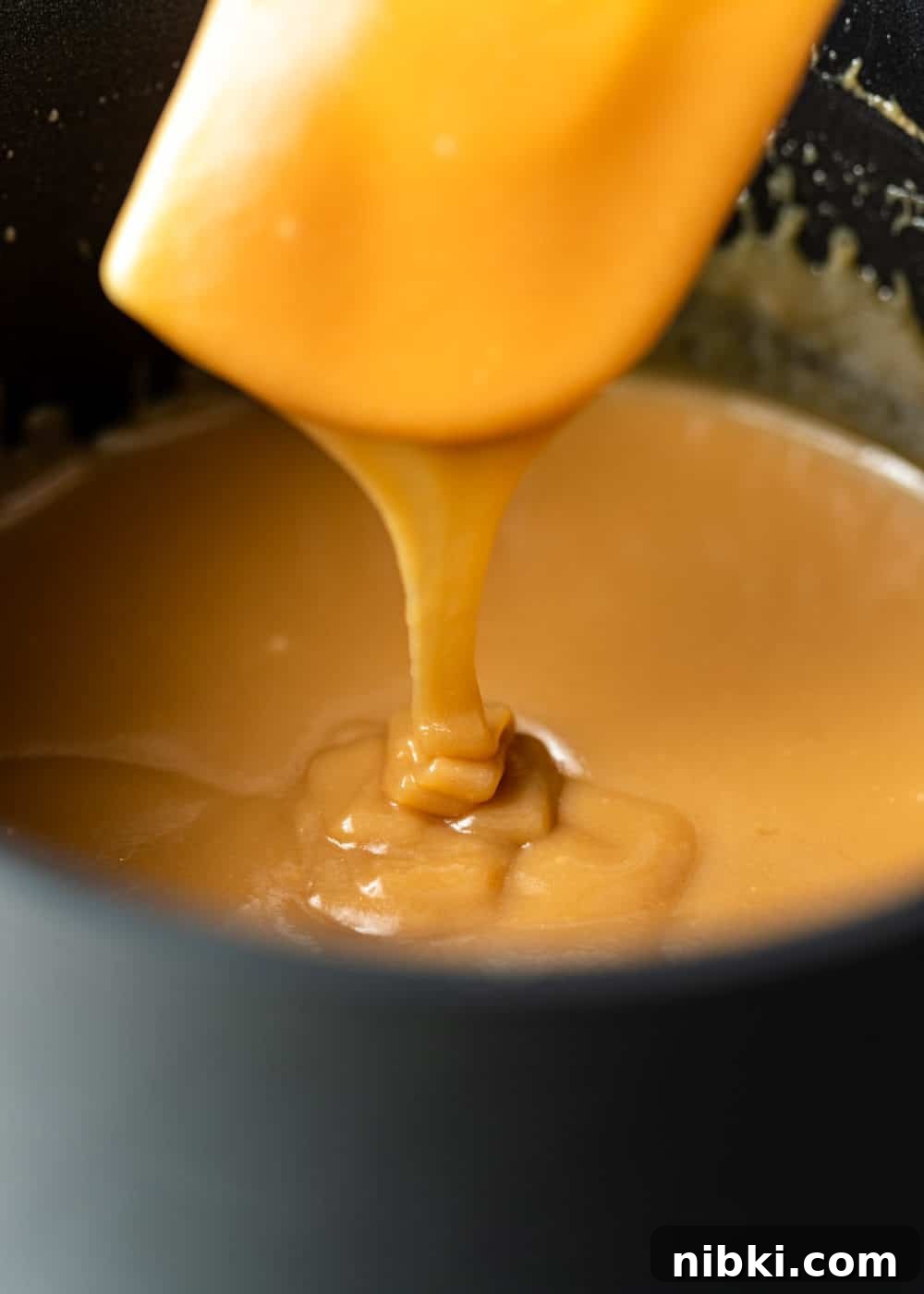 sweetened condensed milk caramel in a pan with a spatula