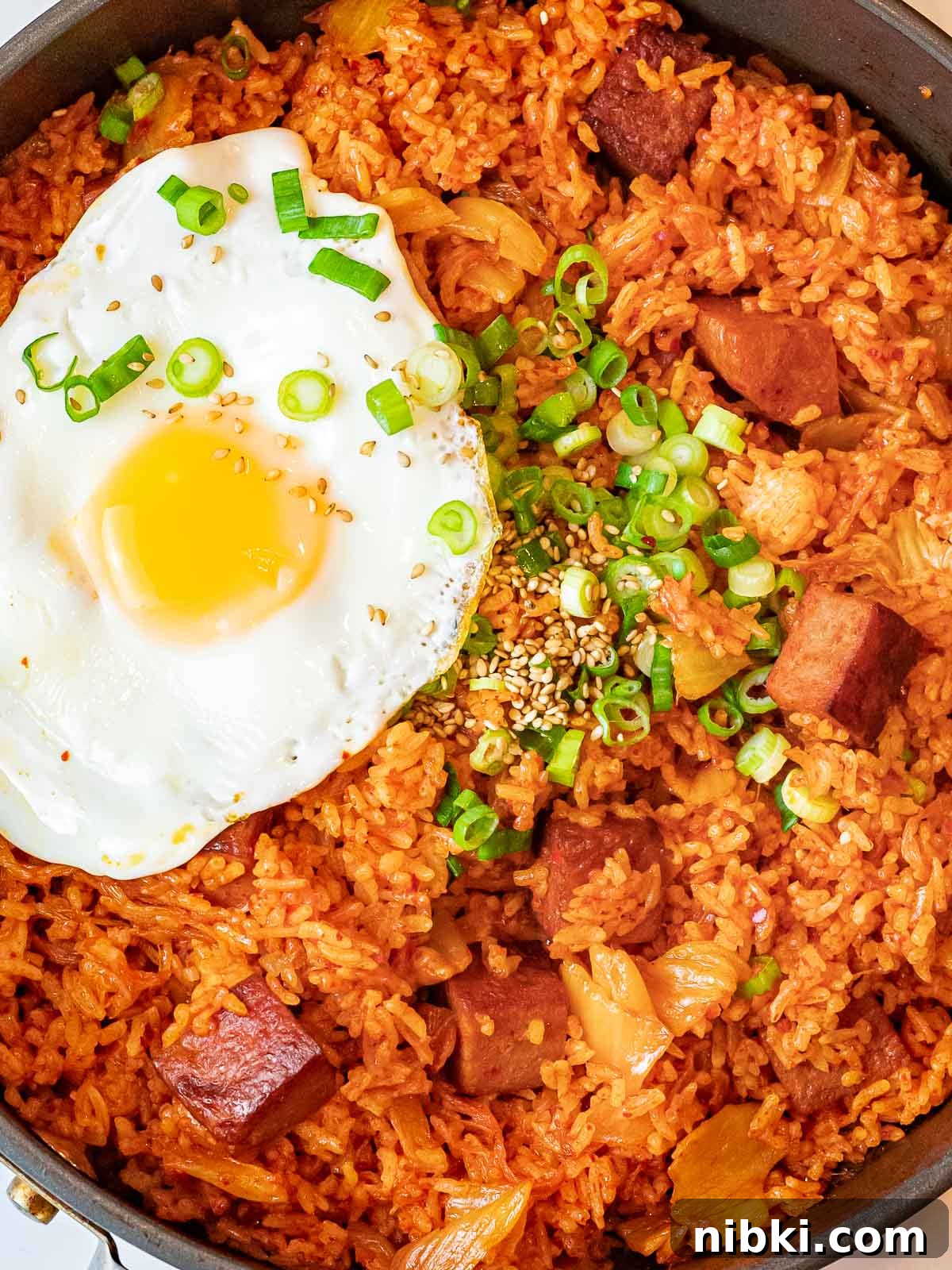 Spicy Kimchi Fried Rice with Crispy Spam 2 kimchi fried with with spam topped with a fried egg and green onions, kimchi