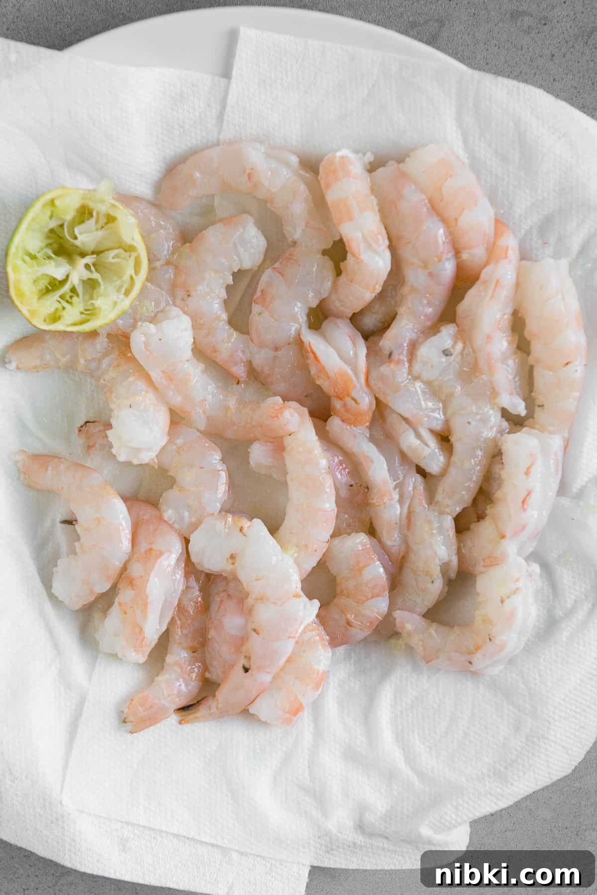 Crispy Baja Shrimp Tacos with Lime Crema 4 raw shrimp on paper towel lined plate