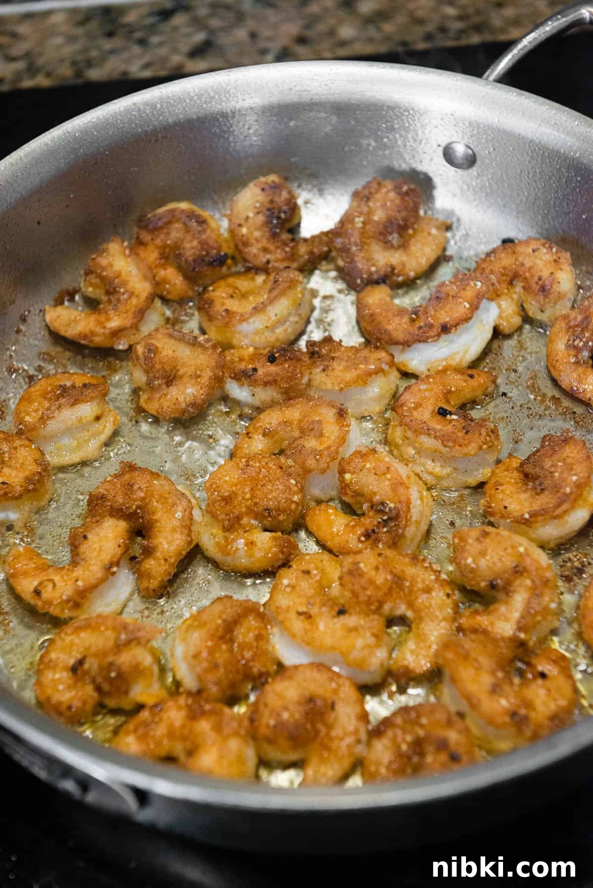 Crispy Baja Shrimp Tacos with Lime Crema 8 fried browned shrimp in pan
